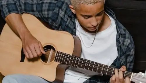 Teenage boy playing a guitar
